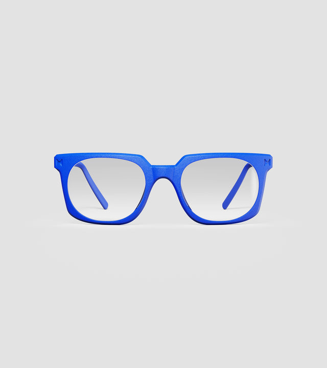 Bold blue square-frame glasses with clear lenses, designed with an inclusive fit for all nose bridges, featuring a modern minimalist design.