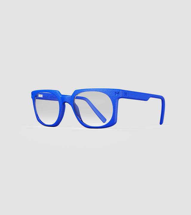 Bold blue square-frame glasses with clear lenses, designed with an inclusive fit for all nose bridges, featuring a modern minimalist design.