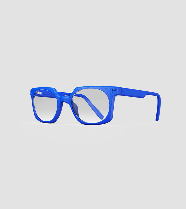 Bold blue square-frame glasses with clear lenses, designed with an inclusive fit for all nose bridges, featuring a modern minimalist design.